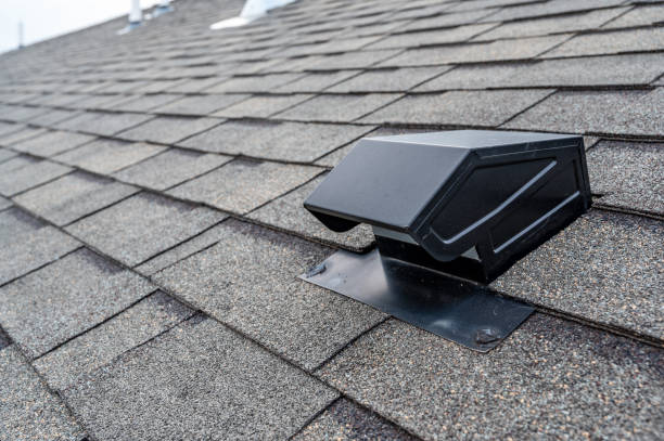A black ventilation box installed on the roof of a house, designed to improve airflow and reduce heat buildup.
