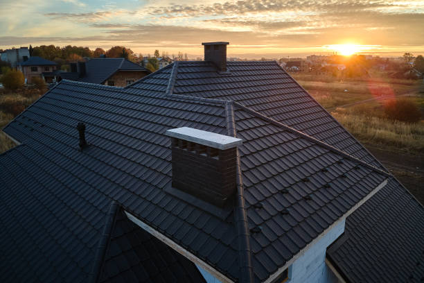 A metal roof featuring a chimney and chimney stack, showcasing the work of a metal roof installer.