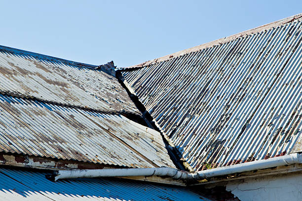 A building featuring a metal roof with a white finish, showcasing the work of a metal roof installer.
