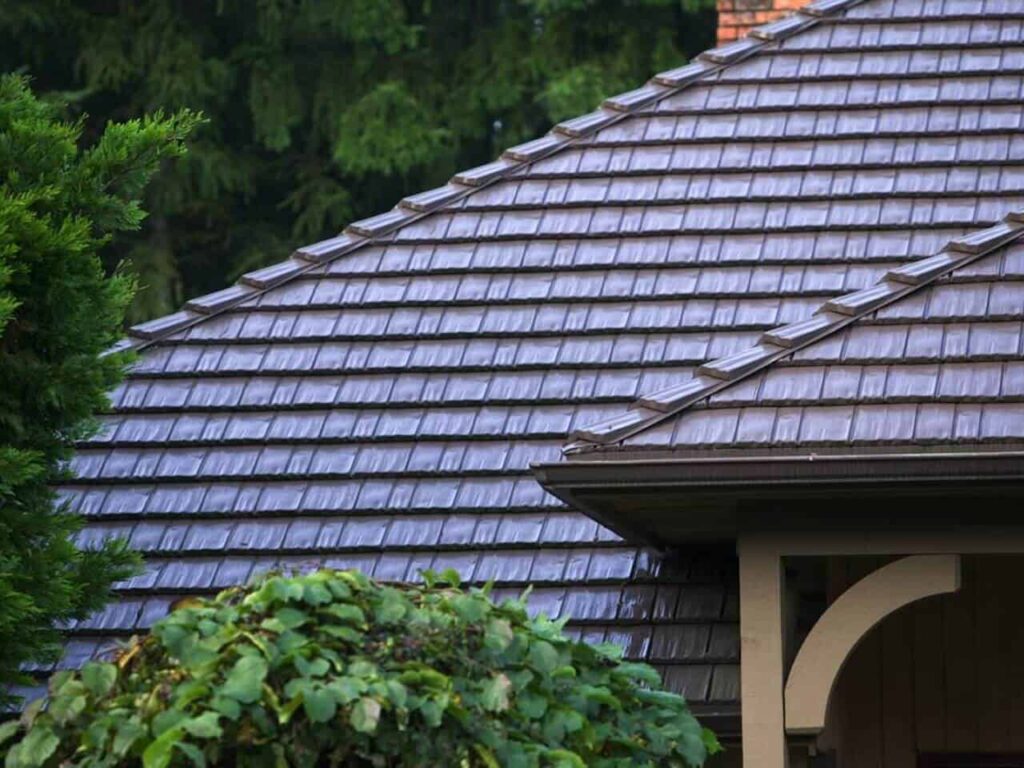 Stone Coated Steel Roofing in Bronx, NY: Durable, Stylish, and Cost-Effective Solutions 2 A stone coated steel roof atop a house, with a lush green tree nearby, showcasing a blend of nature and modern architecture.