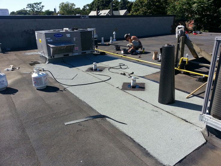 flat roof leak showing need for flat roof repair vs replacement service decision